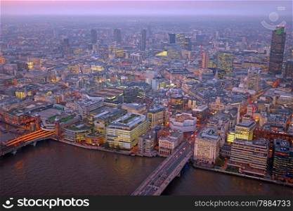 London rooftop view panorama at sunset with urban architectures with Thames River at night