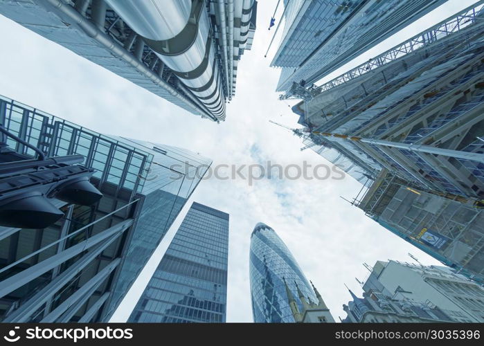 LONDON - SEPTEMBER 2016: London City buildings, skyward view. London attracts 30 million people annually.. LONDON - SEPTEMBER 2016: London City buildings, skyward view. Lo