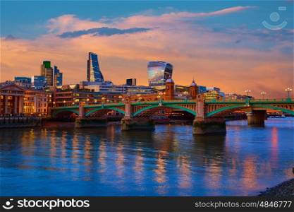 London skyline sunset in Southwark bridge at Thames river UK