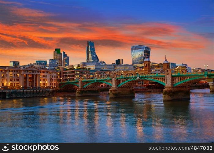 London skyline sunset in Southwark bridge at Thames river UK