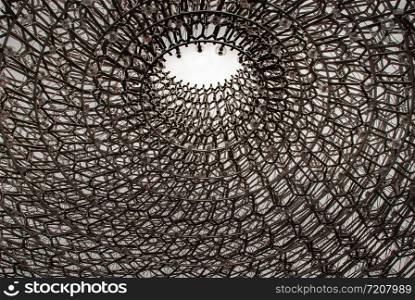 "London, UK - Apr 9, 2019 : Detail on the center of the intricate structure under a clear sky, It is called "The Hive" Designed by Artist Wolfgang Buttress."