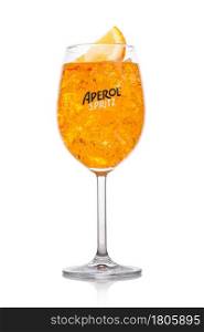 LONDON, UK - APRIL 01, 2020: Aperol Spritz summer cocktail with ice and orange slice in wine glass on white background.