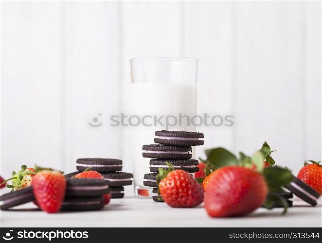 LONDON, UK - MAY 03, 2018: Oreo strawberry original cookies with fresh berries and glass of milk on wooden background.