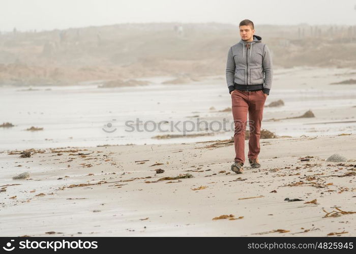 Lone man at beach, autumn. USA Pacific coast landscape, California