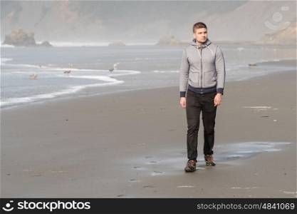 Lone man at beach, autumn. USA Pacific coast landscape, Oregon