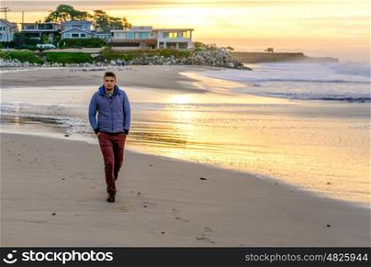 Lone man on beach at sunrise. USA Pacific coast, Santa Cruz, California.