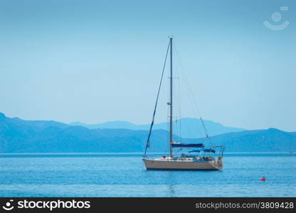 lone sailing yacht drifting in the sea