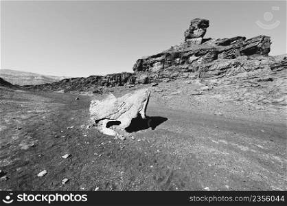 Loneliness and emptiness of the rocky hills of the Negev Desert in Israel. Breathtaking landscape and nature of the Middle East. Black and white photo