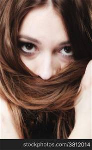 Loneliness stress anxiety and women concept. Closeup portrait beautiful woman dark haired, teen girl covering face by long brown hairs on black