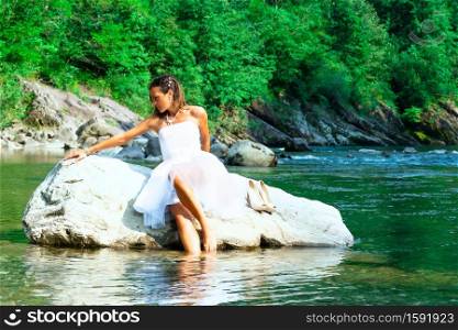 Lonely bride in a rock by the river