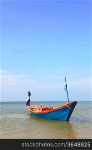 lonely fisherman long tail boat park at the Rayong beach Thailand, vertical