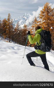 Lonely hiker looking at the wild landscape of Mont Blanc, Italy.