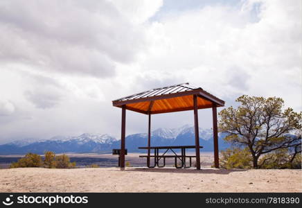 Lonely pergola at the top of the hill surrounded by mountains