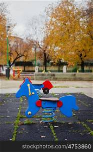 Lonely playground with a blue horse for play