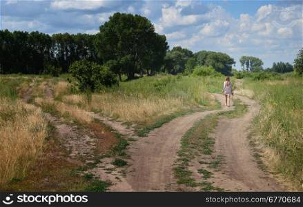 lonely woman walking on country road