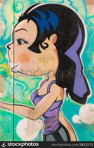 long and black hair purple dressed girl with big lips graffiti, grafito of street art in Leghorn, Tuscany, Italy