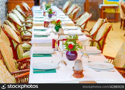 long beautifully set table in a restaurant