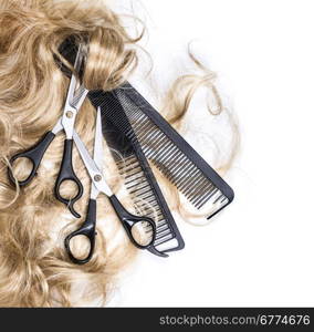 Long blond hair and scissors isolated on white background