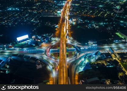 long exposure at night cityscape and ring road with freeway traffic car transportation in Thailand aerial top view