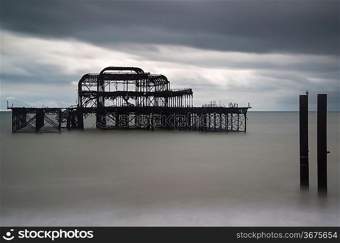 Long exposure blurred sea derelict pier