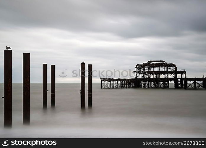 Long exposure blurred sea derelict pier