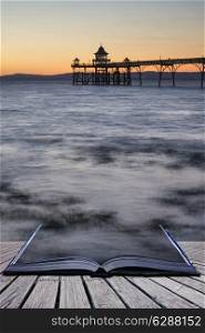 Long exposure landscape image of pier at sunset conceptual book image