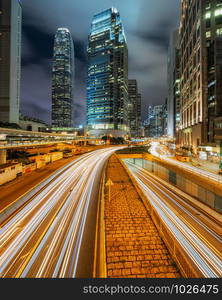 Long exposure of Hong Kong Cityscape skyscaper which have light traffic transportation from car or bus on Central Business District around IFC building, Hong Kong