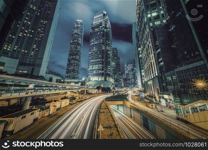 Long exposure of Hong Kong Cityscape skyscaper which have light traffic transportation from car or bus on Central Business District around IFC building, Hong Kong