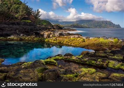 Long exposure of the calm waters of Queen&rsquo;s Bath, a rock pool off Princeville on north shore of Kauai. Long exposure image of the pool known as Queens Bath on north shore of Kauai