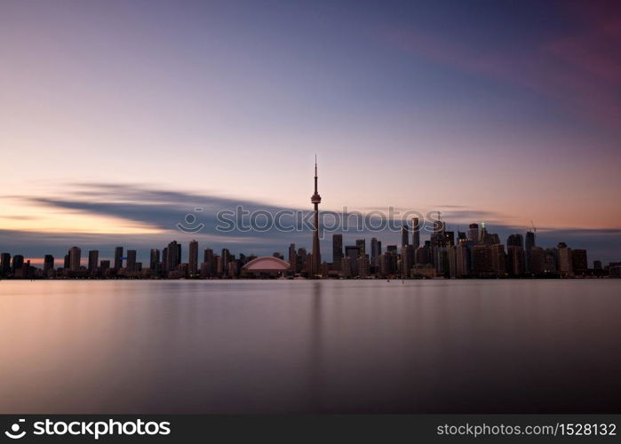 Long exposure of Toronto skyline with Lake Ontario in the foreground, as seen from Center Island.