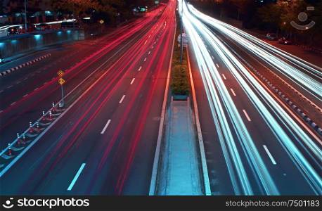 Long exposure photo of traffic with blurred traces from cars, top view.
