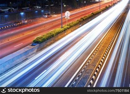 Long exposure photo of traffic with blurred traces from cars, top view.