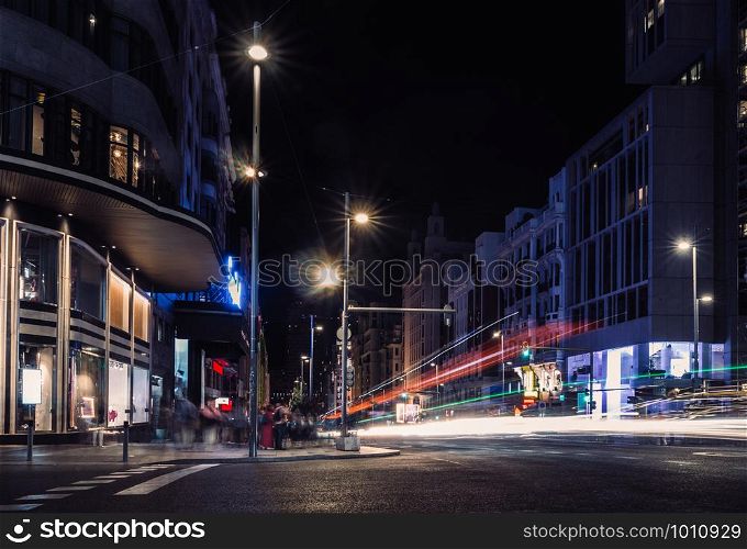 Long exposure shot of pedestrians and traffic in Gran Via, Madrid, Spain at night. Gran Via, Madrid, Spain at night - long exposure