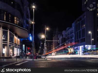 Long exposure shot of pedestrians and traffic in Gran Via, Madrid, Spain at night. Gran Via, Madrid, Spain at night - long exposure