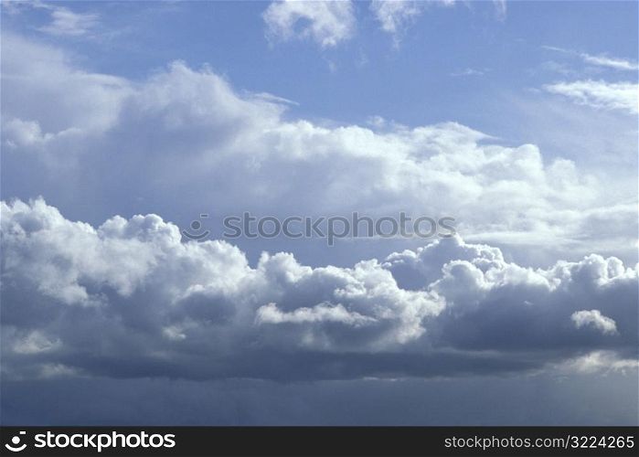Long Flat Cloud In A Cloudy Blue Sky