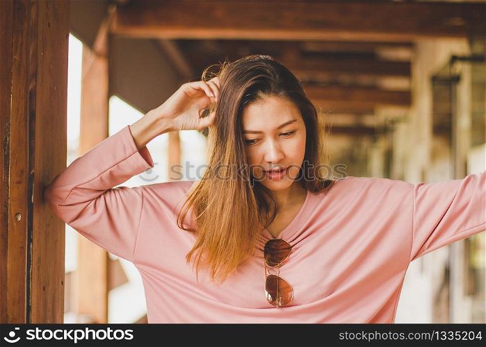 Long hair woman wearing pink shirt looking