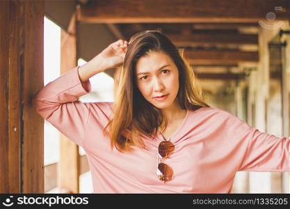 Long hair woman wearing pink shirt looking