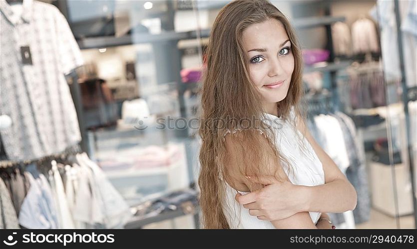 long haired blond 20s girl in the mall, looking at camera