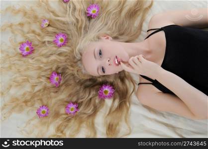Long-haired blonde with flowers in their hair