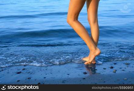 long legs of tall lady walking in water