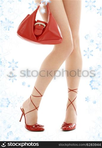 long legs on high heels and red purse with snowflakes