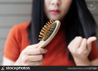 long loss hair on woman brush with and woman looking at her hair