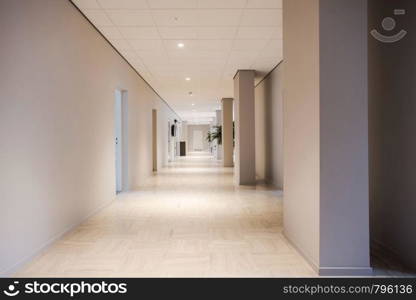 Long office hallway modern design, empty and clean interior white walls. Long office hallway modern design, empty and clean interior