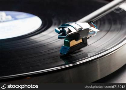 Long Playing record LP on retro record player with tone arm and cartridge
