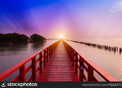 Long Red Bridge sunlight sky tree at beach sea,Red bridge Samut Sakhon Thailand