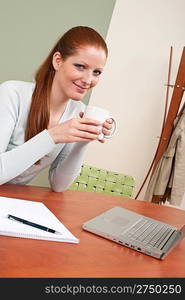 Long red hair woman at office having coffee break