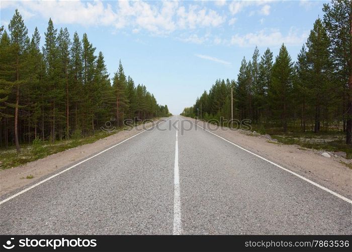 Long road stretching out into the distance under a blue sky. Road to Umba