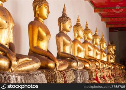 long row of Buddhas in temple art and religion of Thailand.
