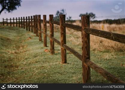 Long rustic wooden fence in the landscape