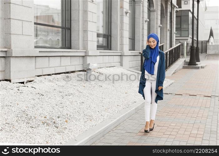 long shot gorgeous girl with hijab smiling